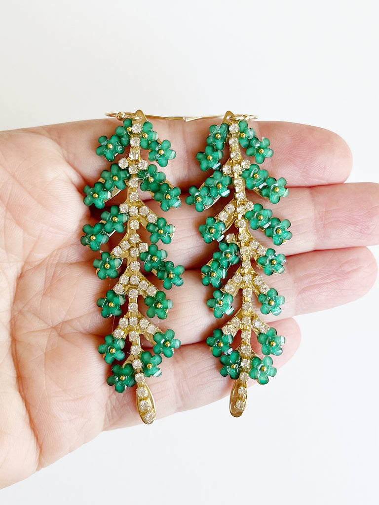 Green Flower Leaf Dangle Statement Earrings displayed on hand