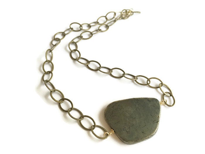 Sliced pyrite stone hand wired onto yellow gold antique brass plated chain necklace.