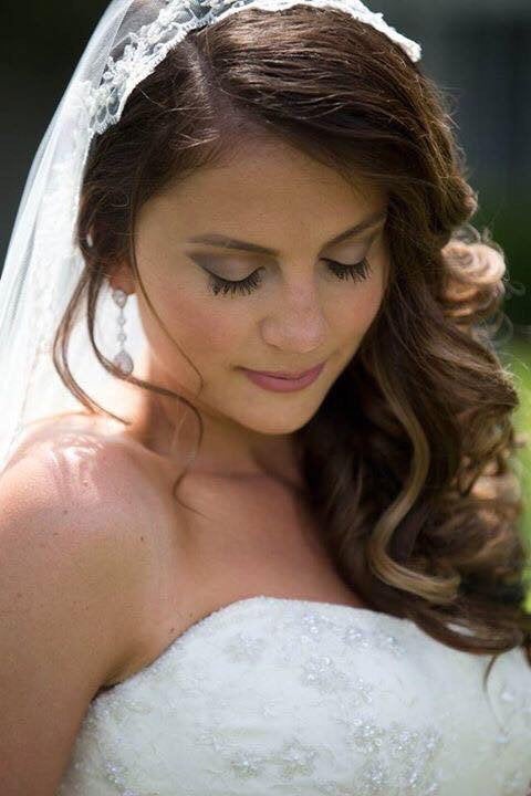 Bride wearing Long Clear cubic zirconia teardrop crystal earrings in a silver colored rhodium plated brass setting.