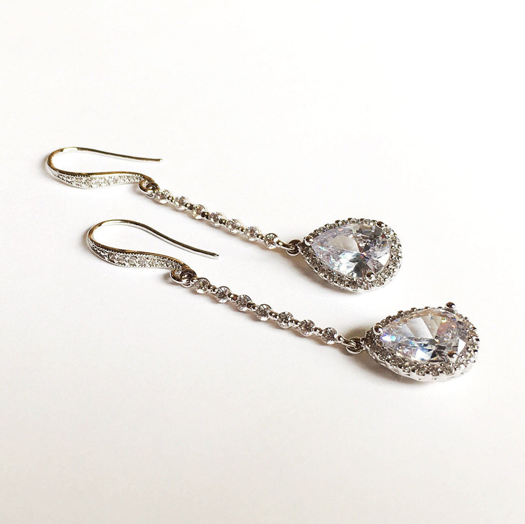 Long Clear cubic zirconia Crystal Drop Earrings in a silver colored rhodium plated brass setting.
