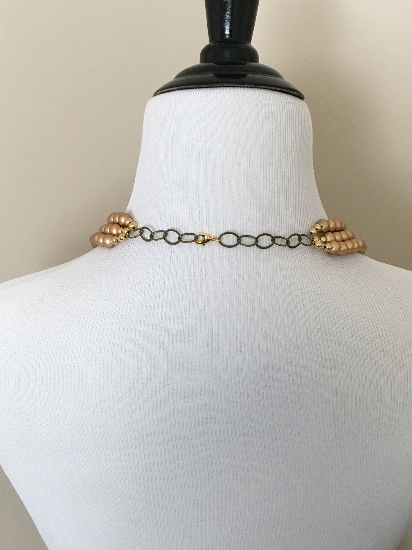 Back of mannequin wearing necklace with adjustable chain on lobster claw clasp