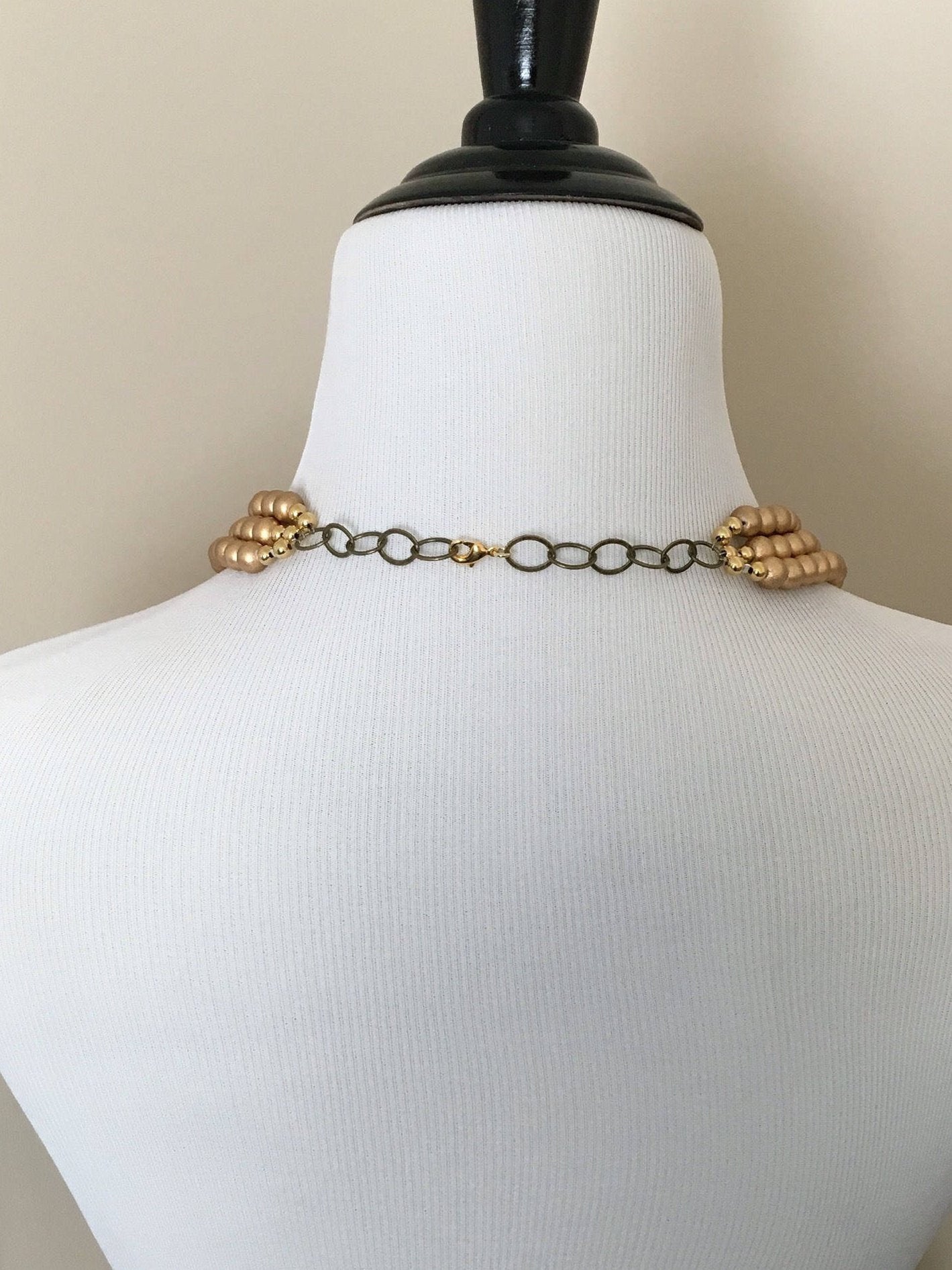 Mannequin turned around to show adjustable chain and lobster clasp on necklace.