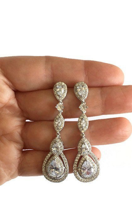 Hand holding Long Crystal Drop Earrings for Brides