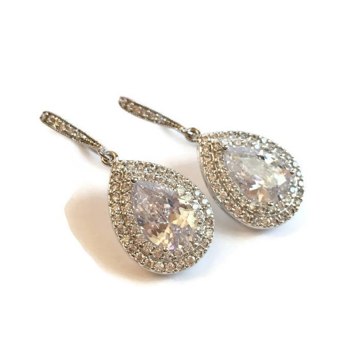 Double Halo clear Cubic Zirconia Teardrop Crystal earrings in a silver colored rhodium plated brass setting.