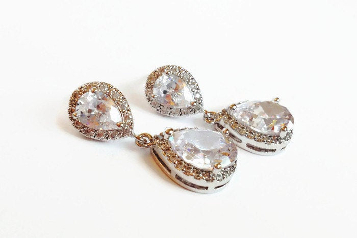 Cubic zirconia teardrop crystal earrings in a silver colored rhodium plated brass setting.