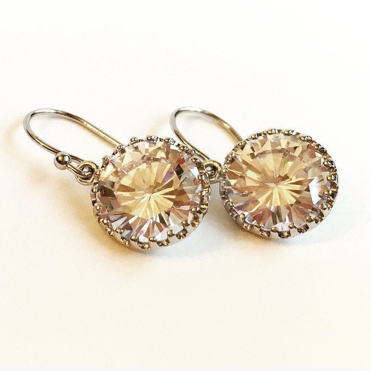 Close up of Round cubic zirconia stone earrings set in a silver brass setting. 
