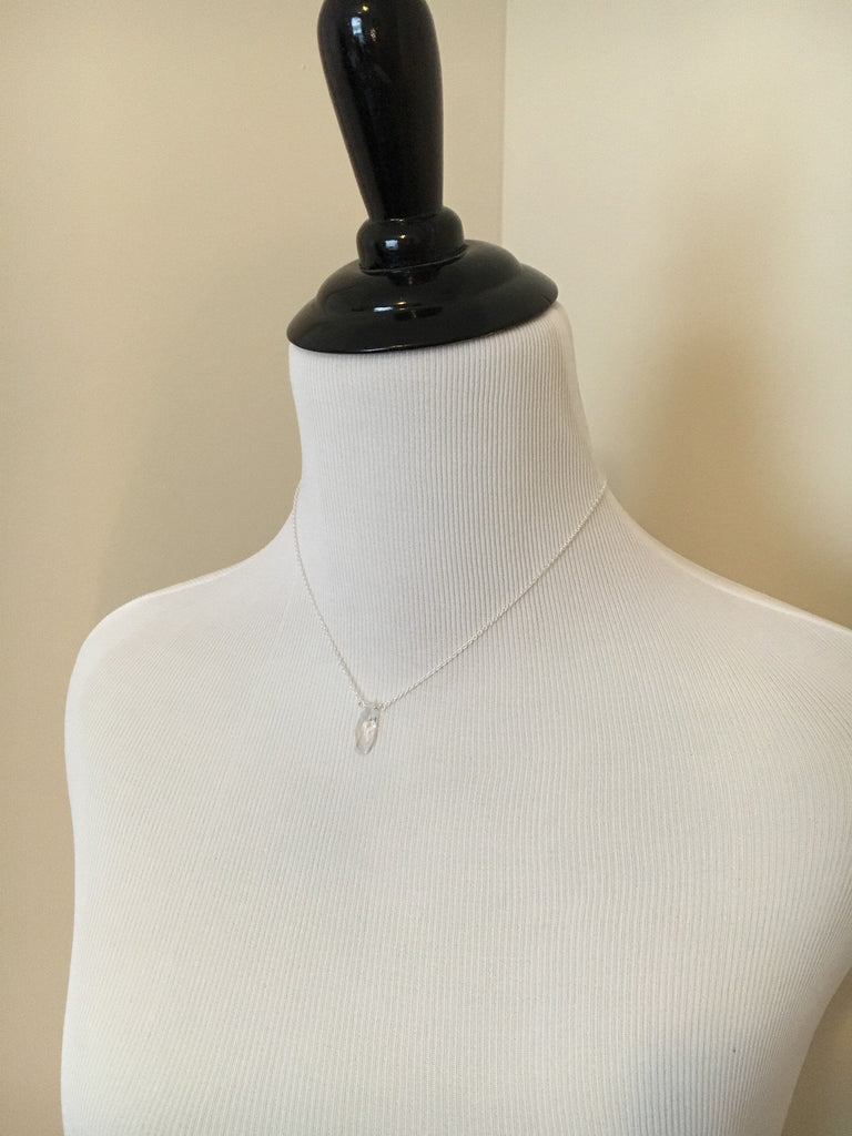 Mannequin wearing Cubic zirconia teardrop clear crystal pendant on gold filled chain necklace 