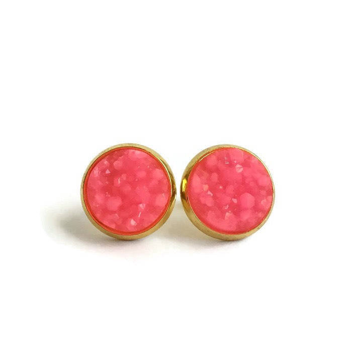 Hot pink resin druzy stone stud earrings set in a yellow gold color setting. 