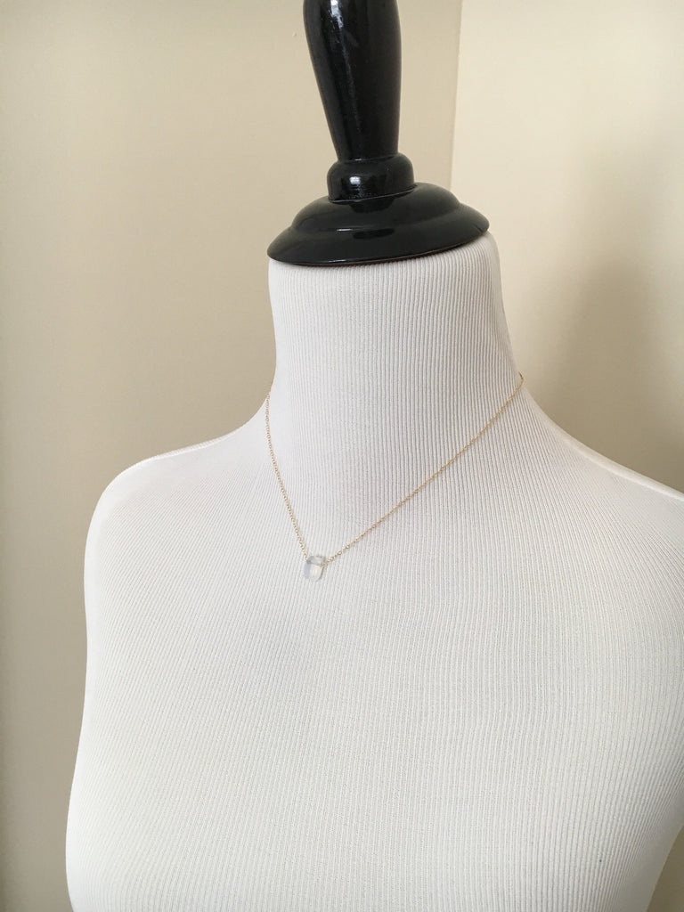 Genuine crystal white opal pendant on 14kt gold filled chain displayed on mannequin.