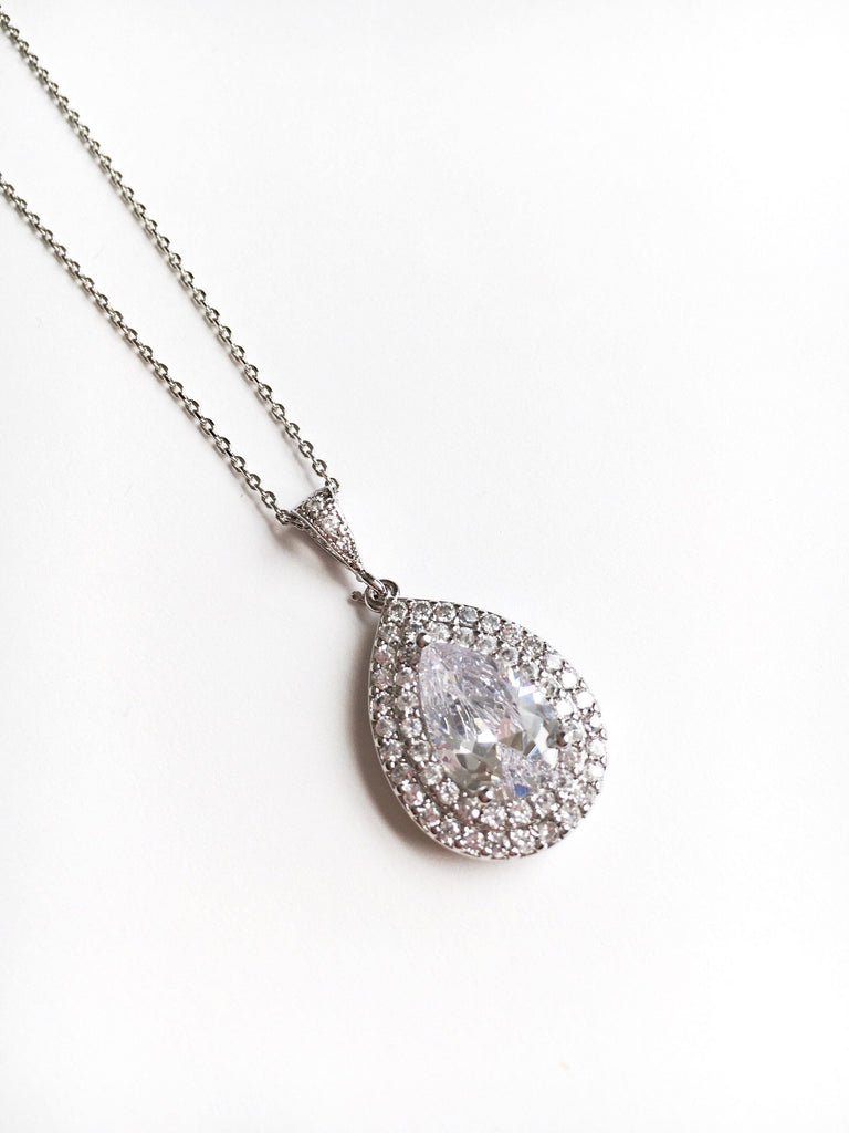 Double halo Teardrop cut cubic zirconia crystals set in silver color rhodium plated brass pendant necklace
