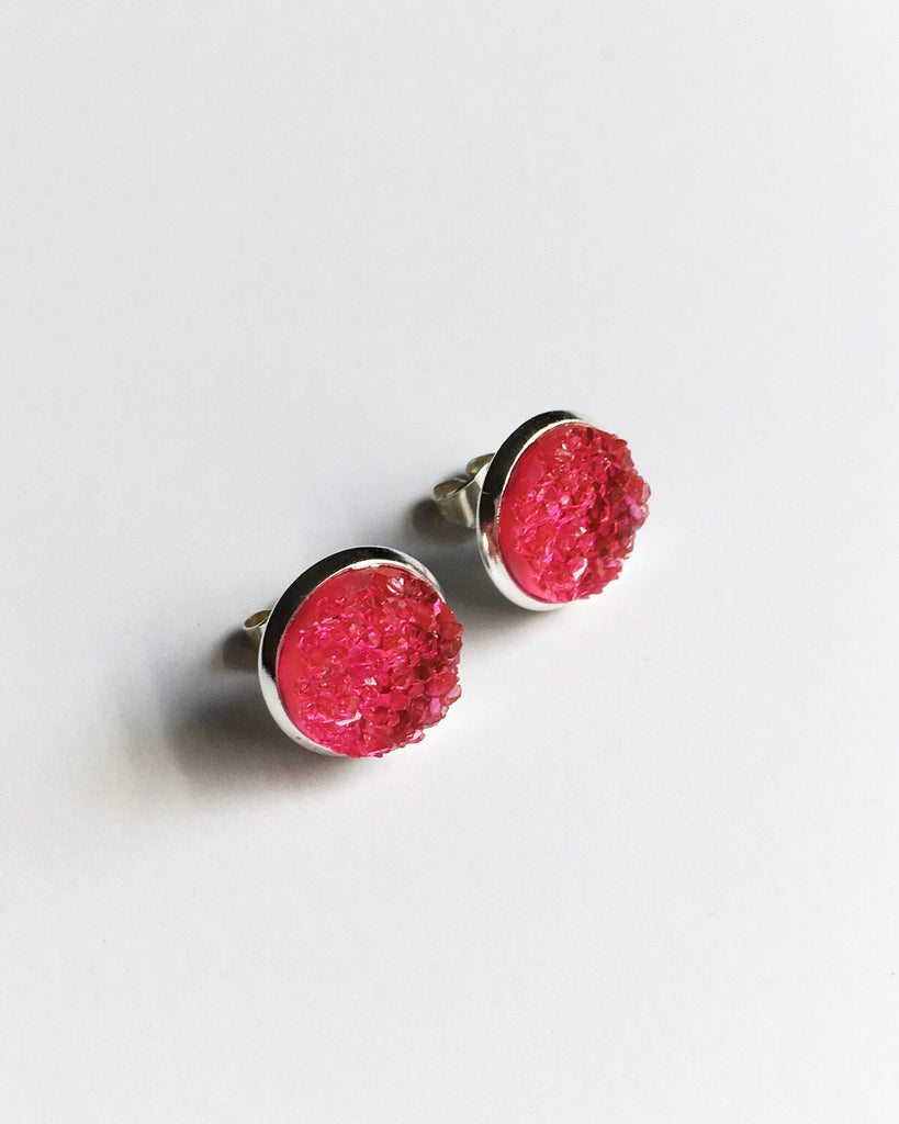 Side top view of Flamingo Pink Druzy stone Stud Earrings in a silver setting.