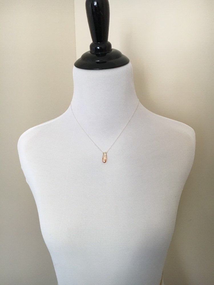 Mannequin wearing Small champaign teardrop crystal on a sterling silver chain from the front.