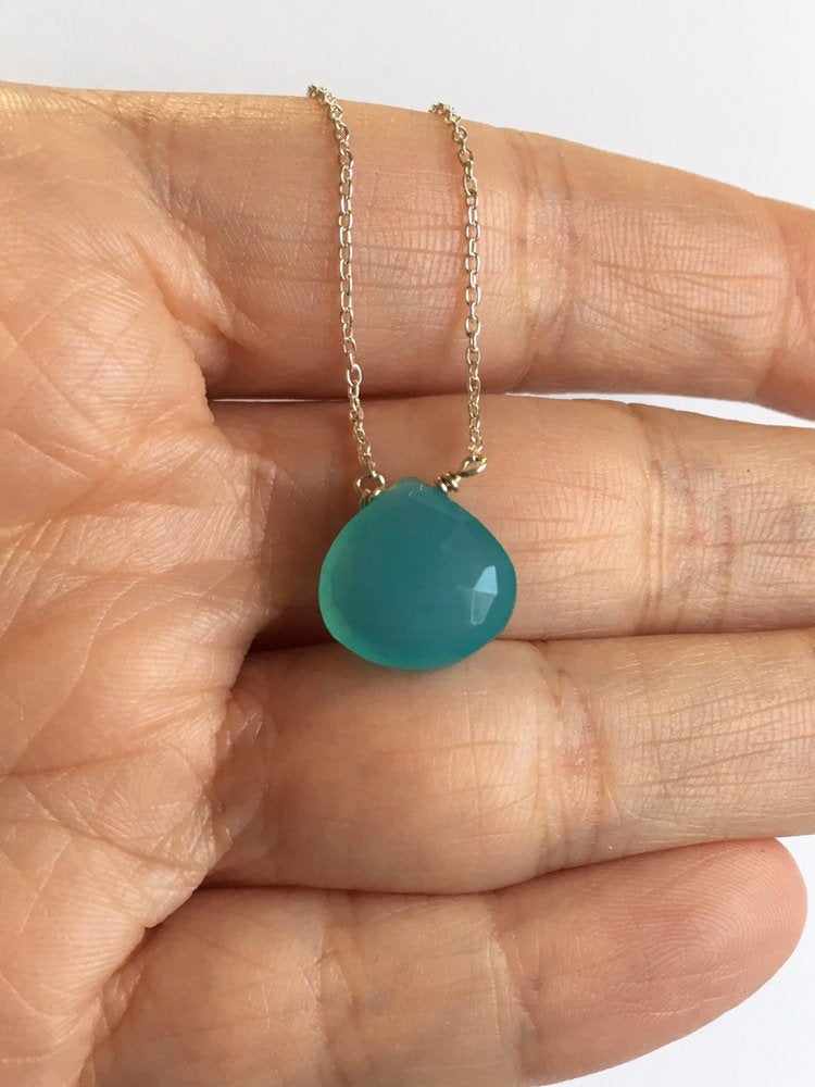 Aqua Chalcedony Teardrop Pendant Necklace with Sterling Silver Chain draped over fingers.