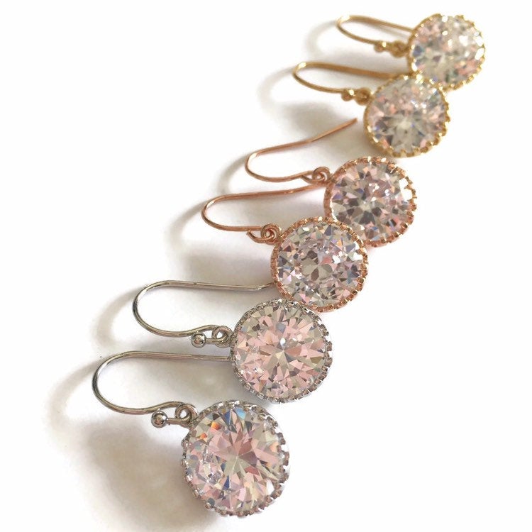 Round cubic zirconia stone earrings set in a silver, yellow gold and rose gold plated brass setting. 