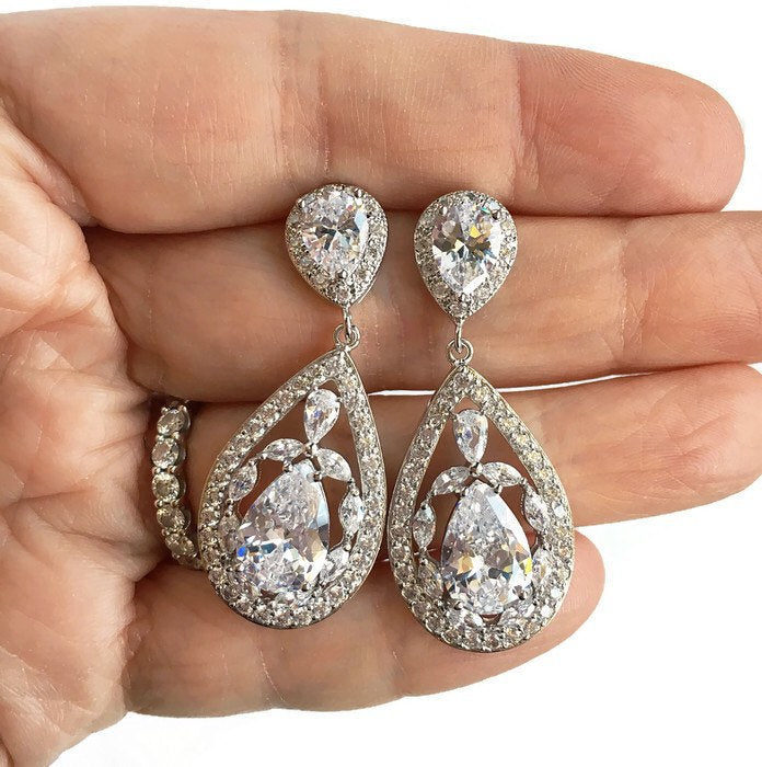 Long Floral Teardrop Crystal Drop Earrings in womens hand.