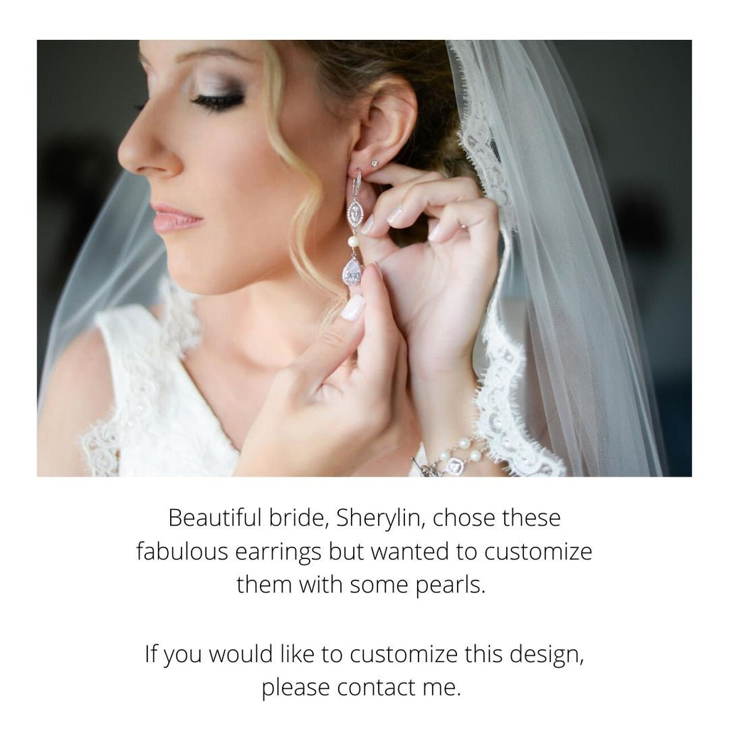 Bride wearing Clear cubic zirconia teardrop crystals in a silver colored rhodium plated brass setting earrings.