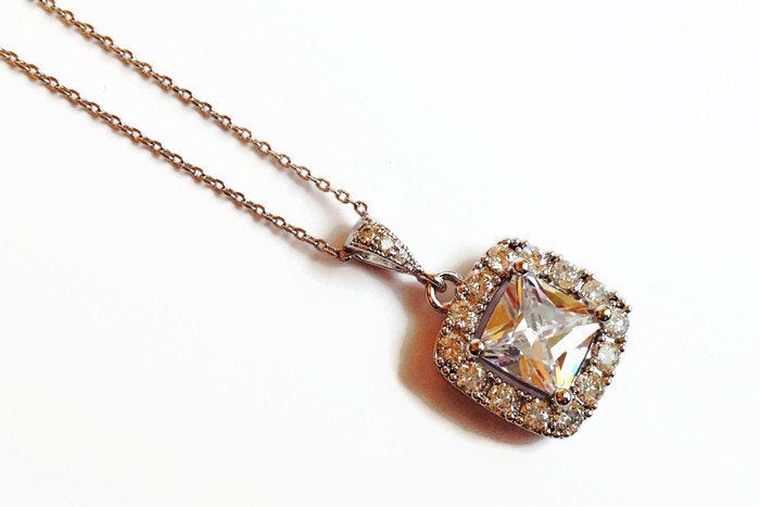 Cubic zirconia square crystal necklace in a silver colored rhodium plated brass setting.