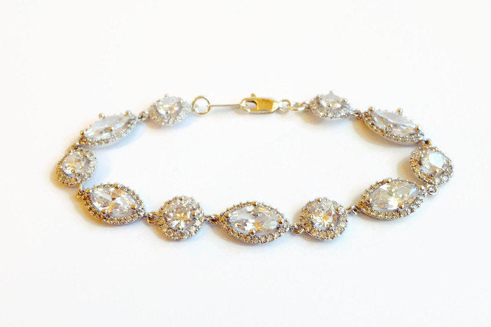 Marquise and Round Halo Crystal Cubic zirconia crystals set in silver color rhodium plated brass bracelet.