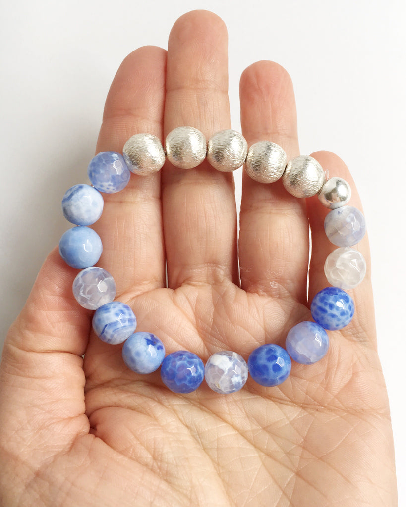 Hold holding White and Blue Lace Agate and Silver Stacking Beaded Bracelets on palm