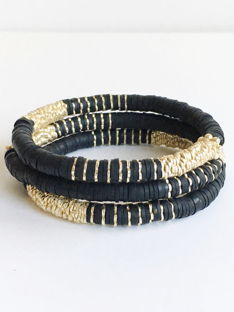 Three Black Confetti and Gold Beaded Stretch Bracelets stacked.