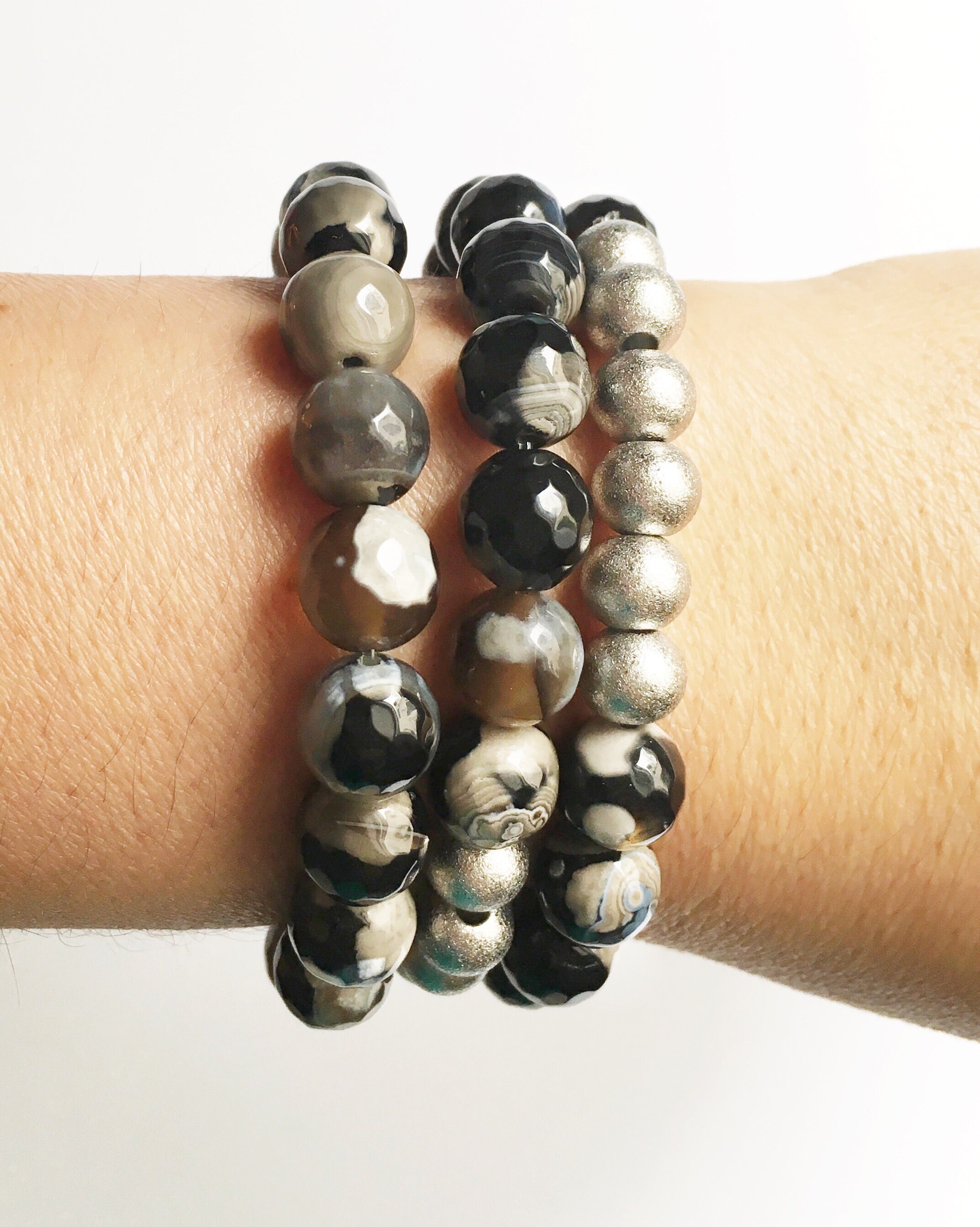 Women's wrist wearing three Black and Gray Agate with Silver Stacking Beaded Stretch Bracelets
