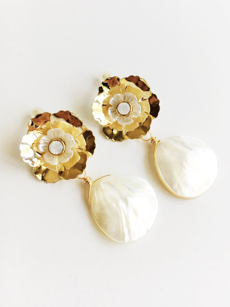 Gold and white flower with mother of pearl teardrop dangle earrings.