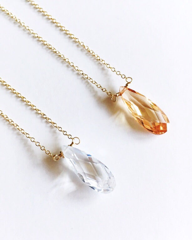 Cubic zirconia teardrop crystal pendant on gold filled chain necklace – available in clear or champaign  - laying sideways.