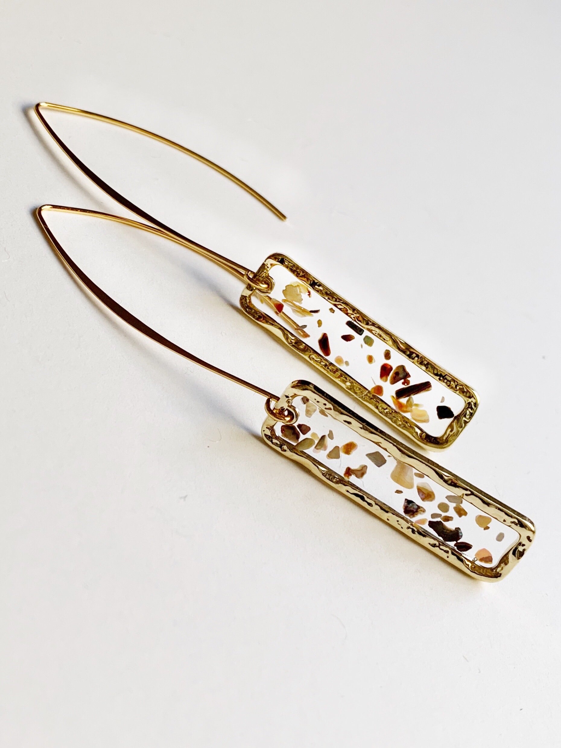 mother of pearl shell in epoxy resin setting with gold plated wire dangle earrings. 