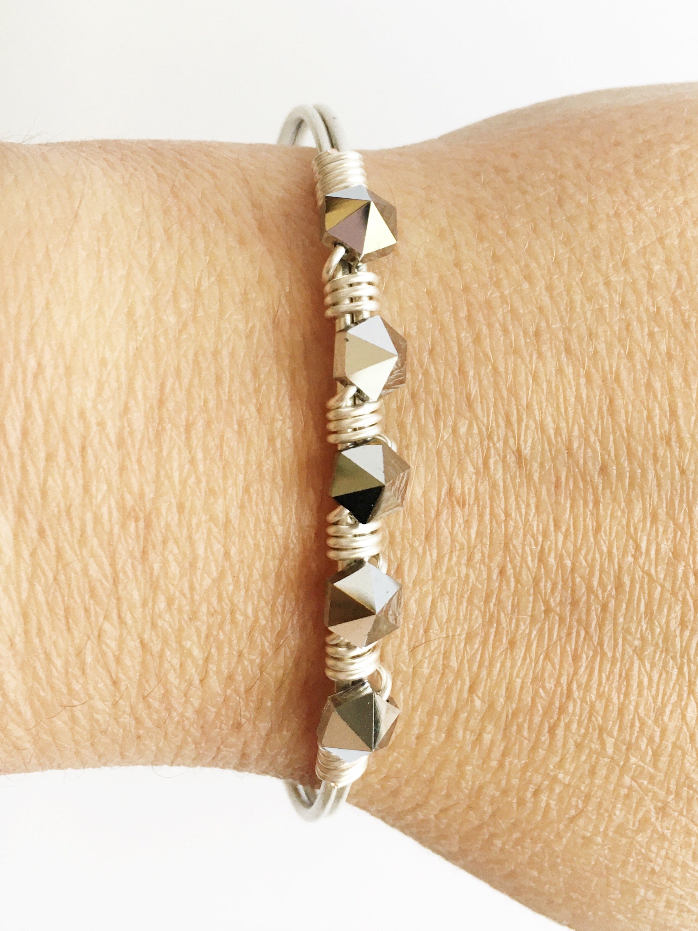 silver beaded bracelet on womens wrist