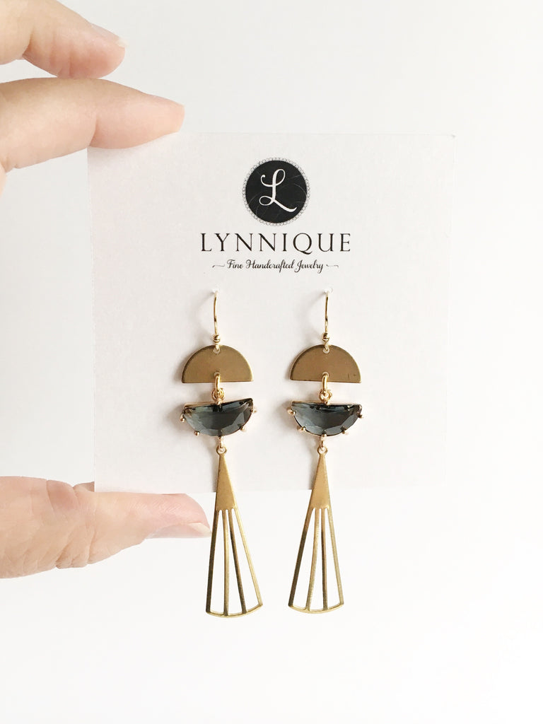 Long gold teardrop with gray glass accent dangle earrings on display card.