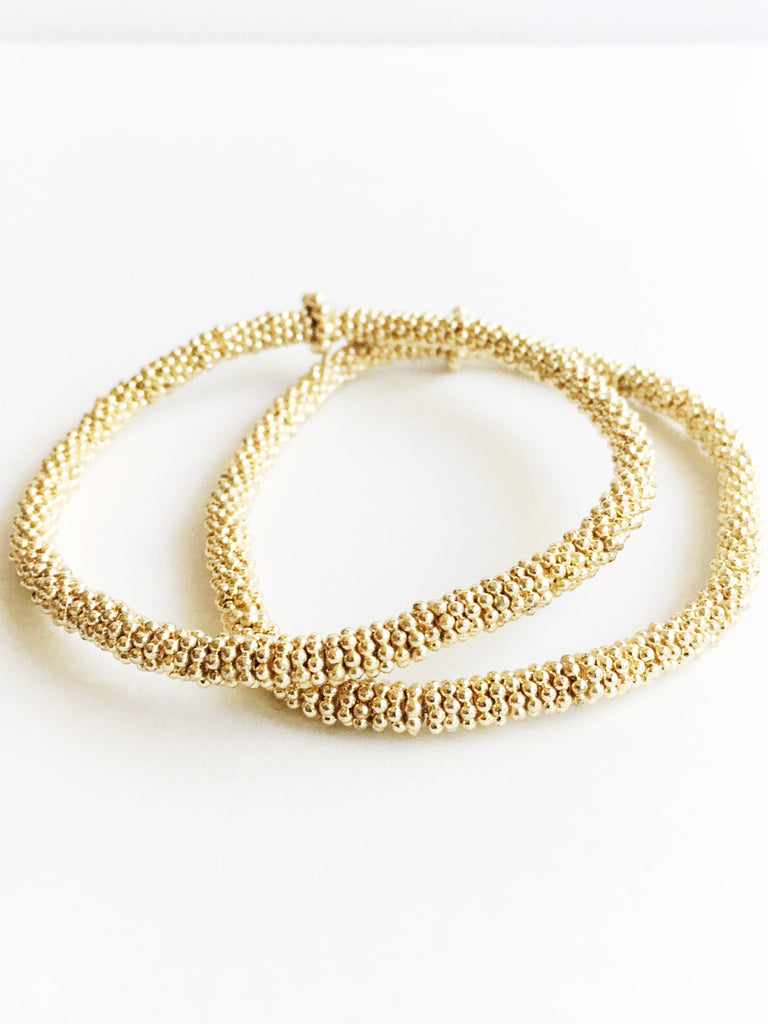 two gold bead bracelets