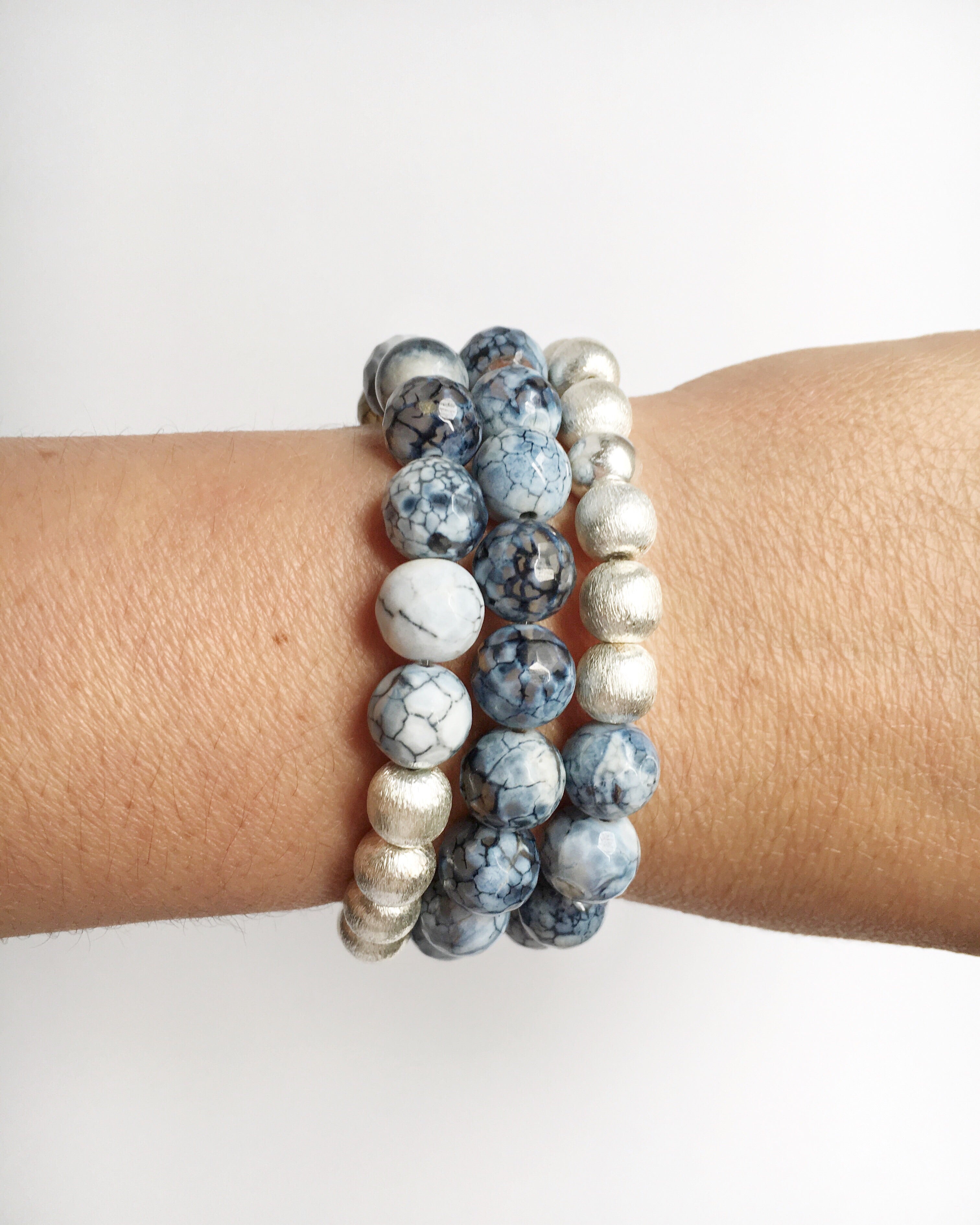 Women's wrist wearing three Black Lace Agate and Silver Stacking Beaded Stretch Bracelets