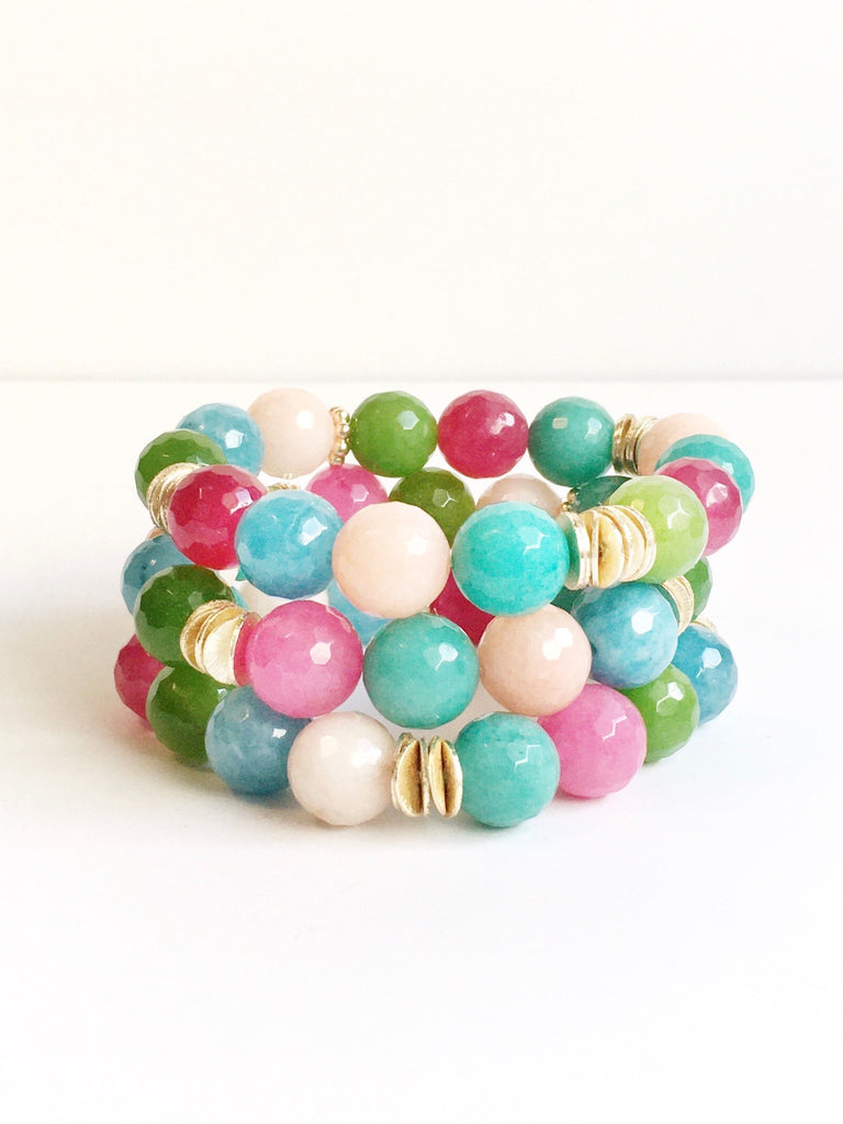 Three Hand strung agate and gold plated beads on stretch material stacked on each other.