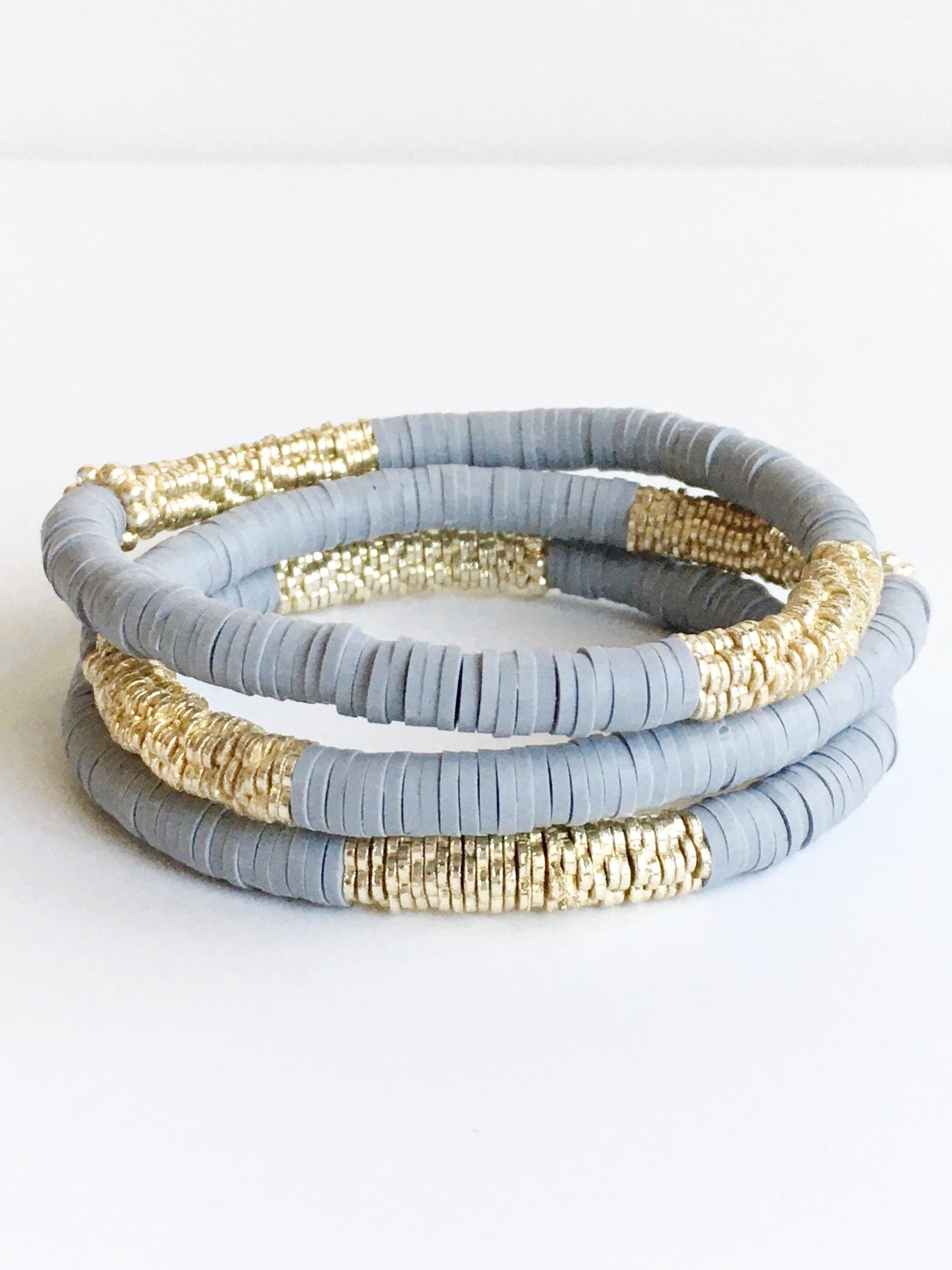 Three Dark Gray Confetti and Gold Beaded Stretch Bracelets stacked.
