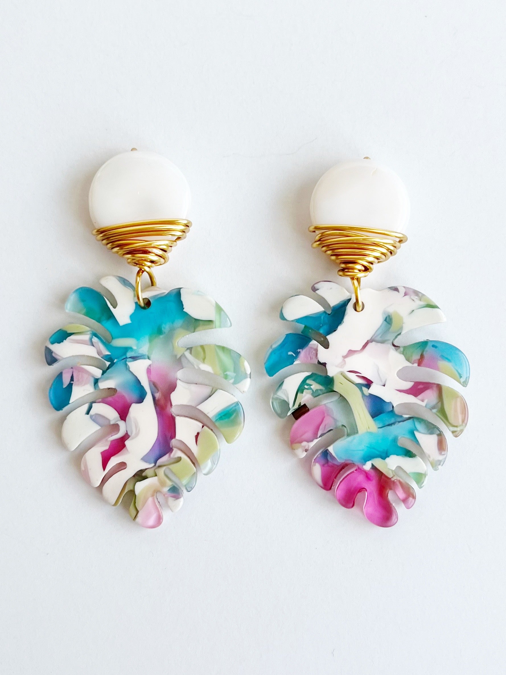 Mini Palm Dangle Leaf Earrings in Blue, Pink, and White wrapped with gold plated wire earrings.