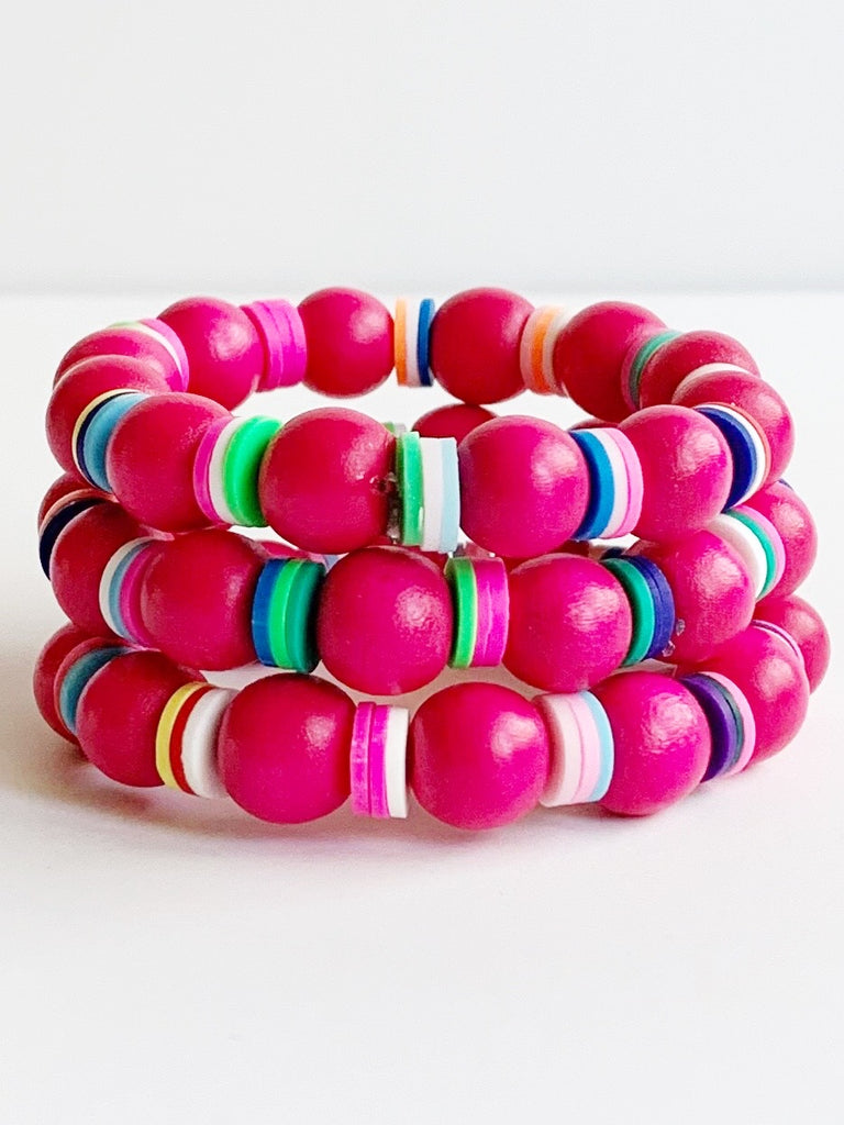 Three Child sized Lipstick Pink and rainbow confetti beaded stretch bracelets stacked.