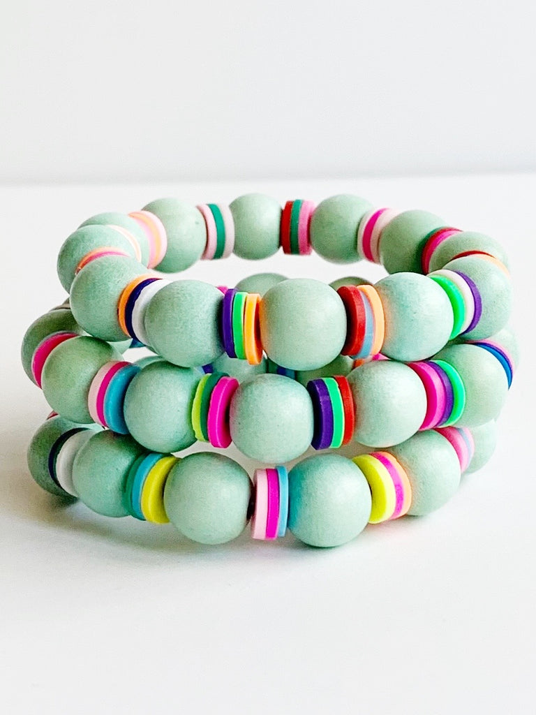 Three Child sized sea foam wood and rainbow beads on stretch material bracelets.