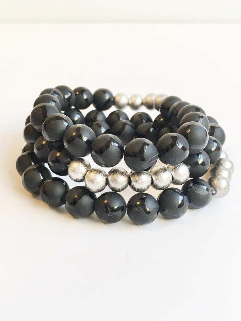 Three Black Giraffe Agate and Stardust Stainless Steel Beaded Stretch Bracelets stacked.