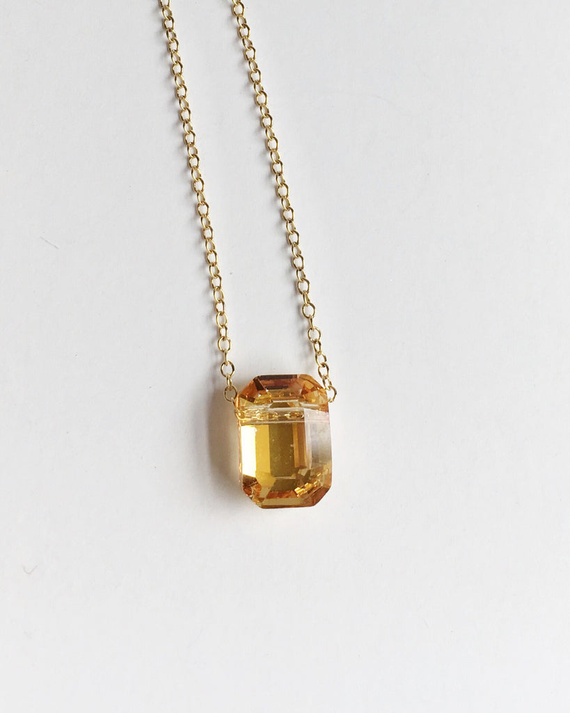 Small Golden Yellow Crystal and Gold Pendant chain Necklace hanging.