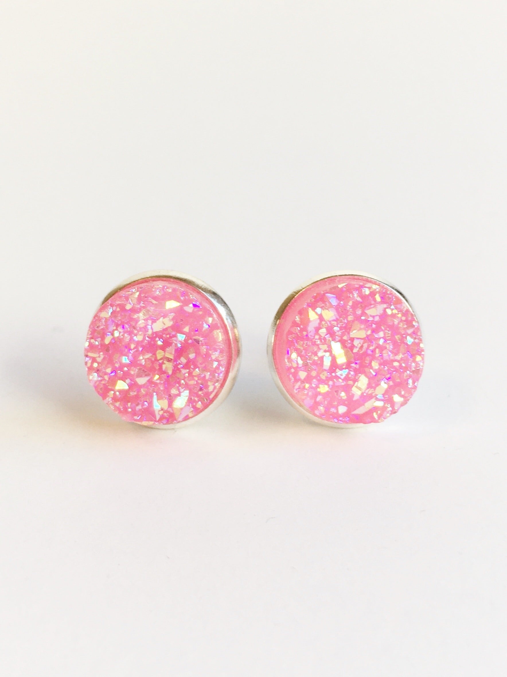 Bright Pink resin druzy stone stud earrings set in a silver color setting. 