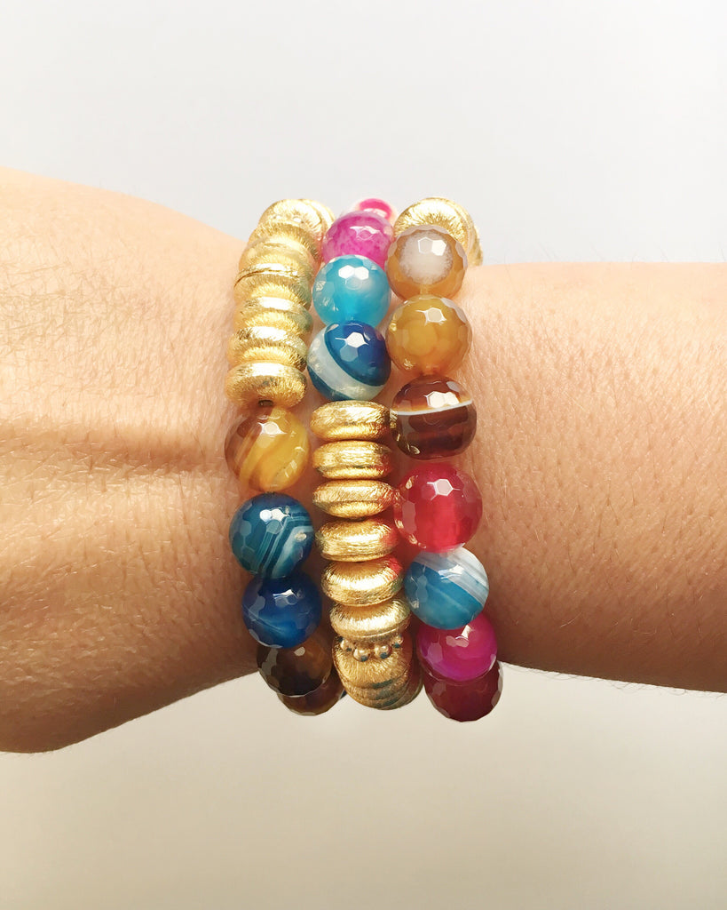 Women's wrist wearing three Multi Color Agate and Gold Agate Stacking Beaded Bracelets