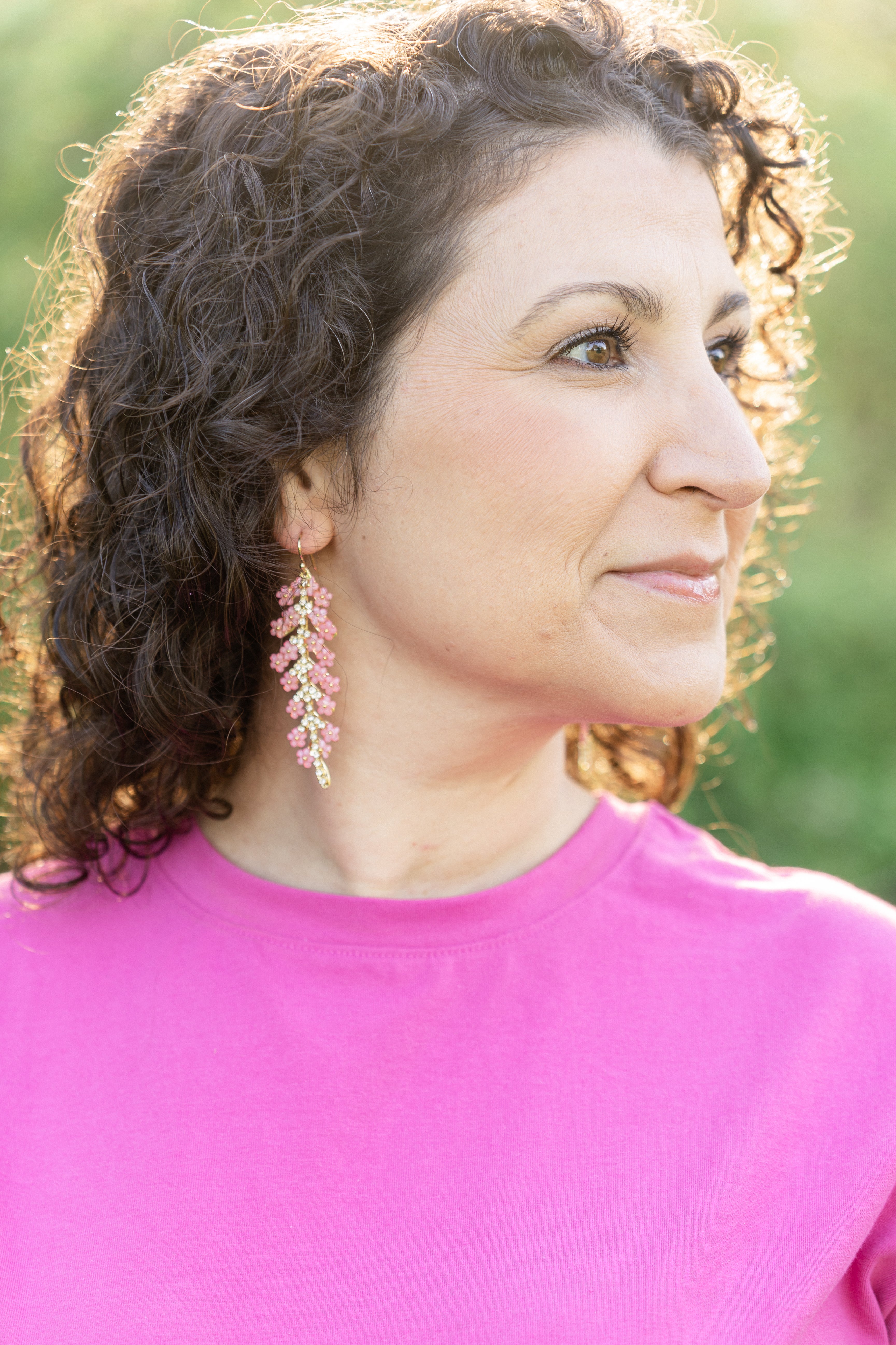 pink flower drop earrings modeled on woman