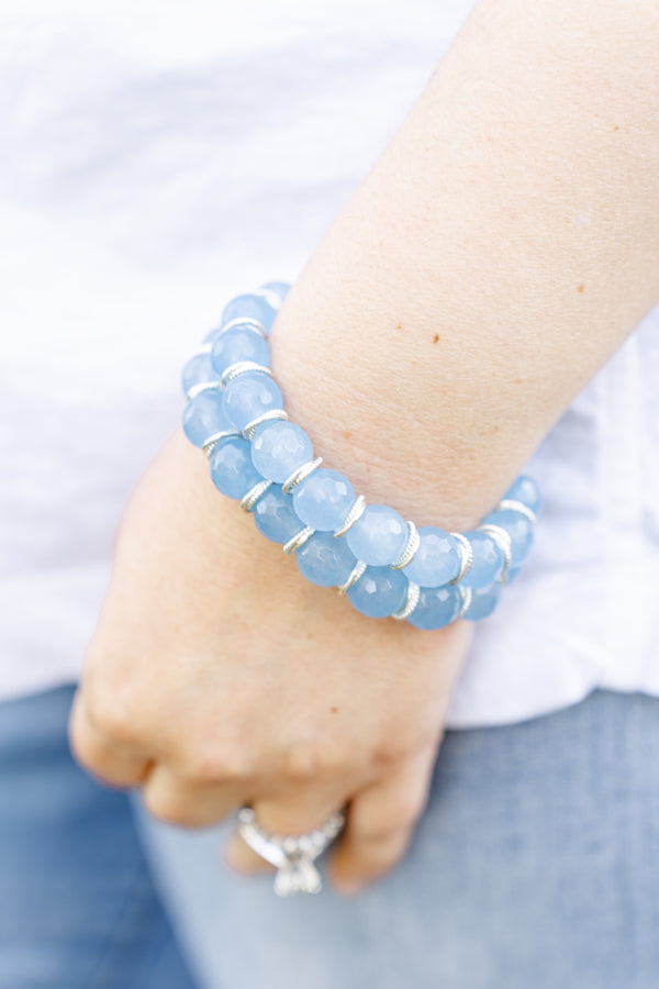 blue beaded bracelets with silver accents modeled on hand