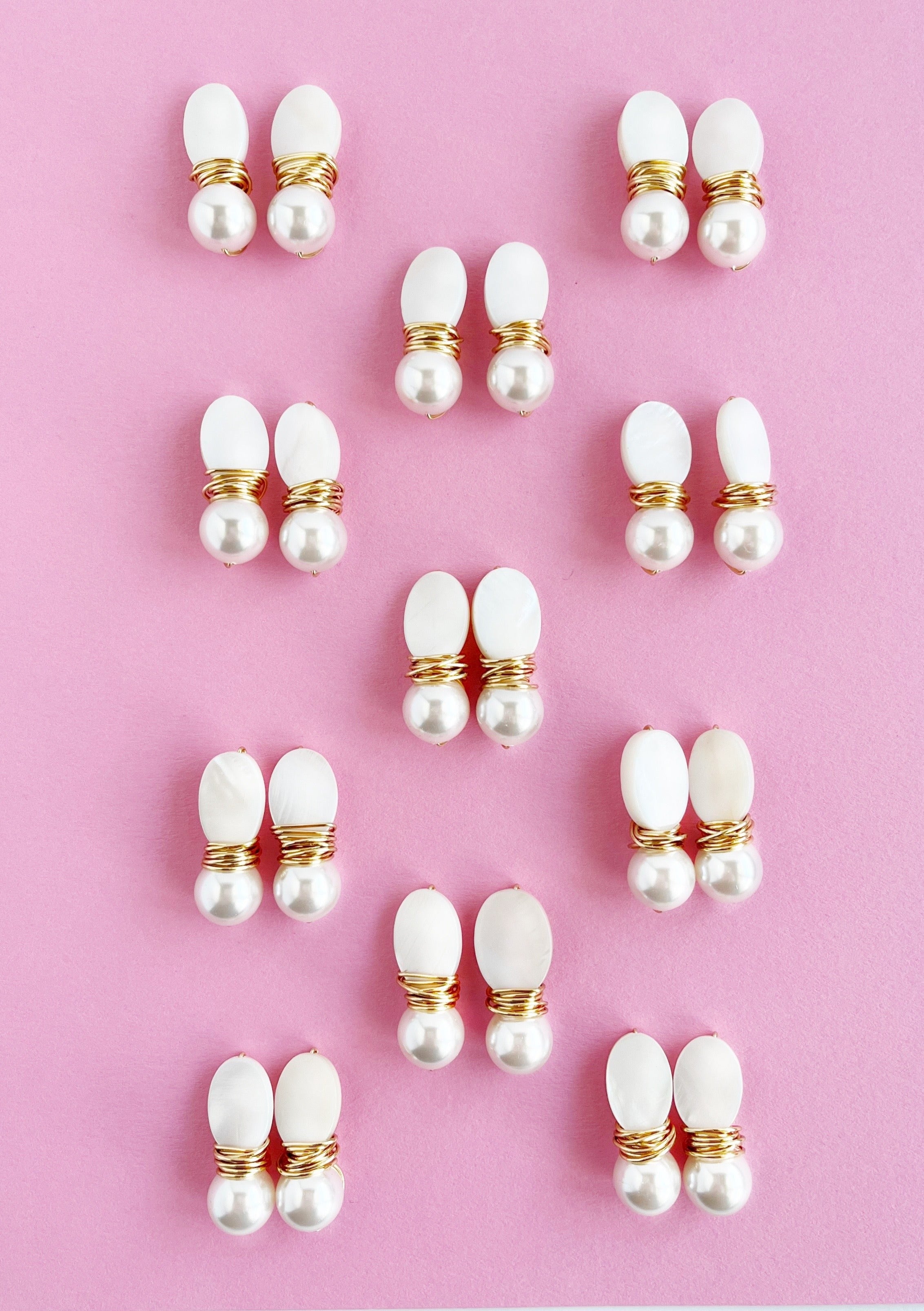 11 pairs of pearl stud pearl drop earrings with gold on pink backing
