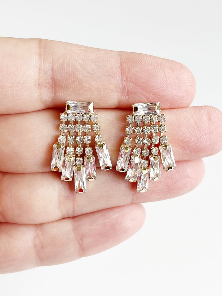 Crystal womens stud earrings displayed on hand