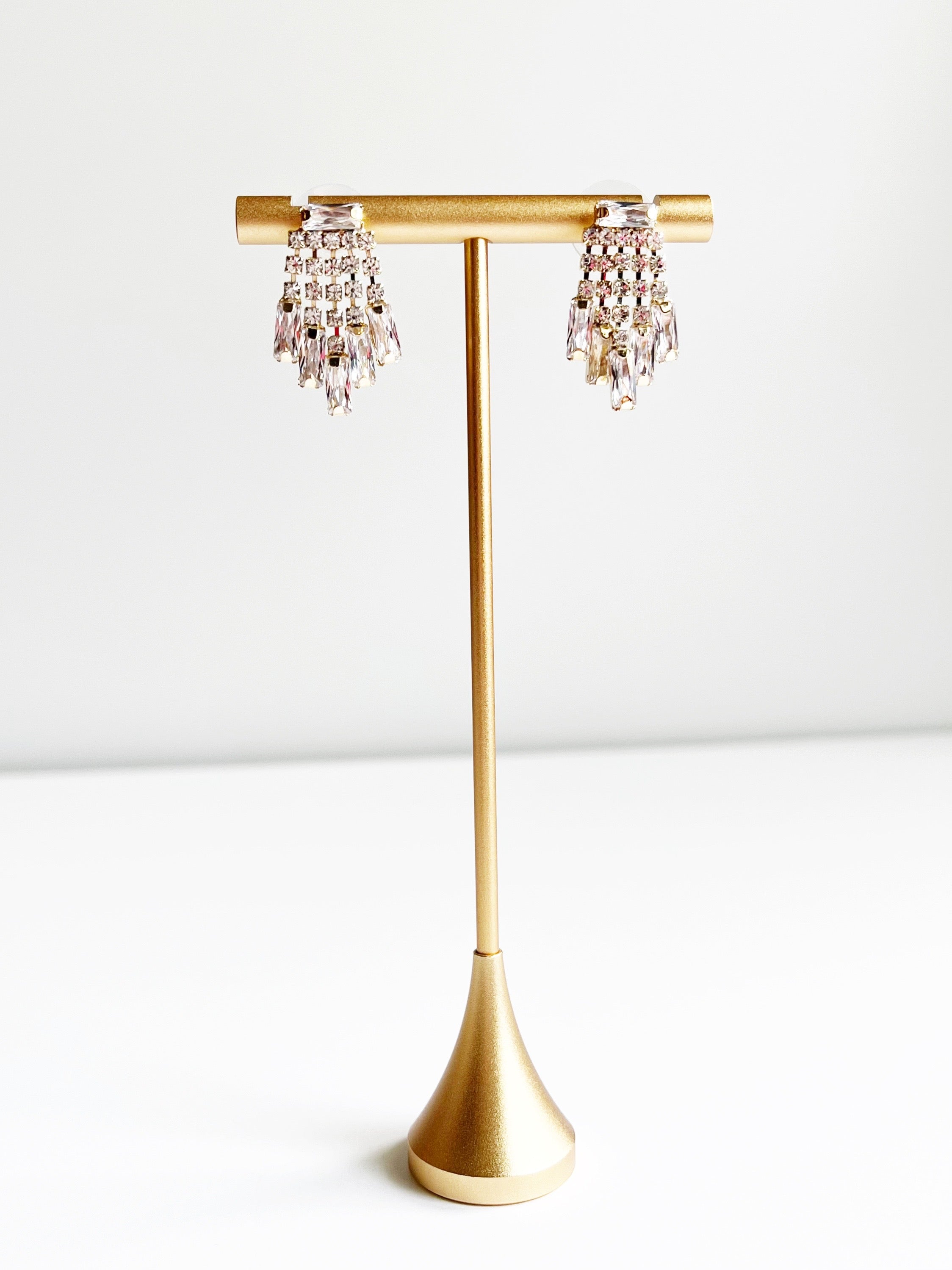 Crystal Earrings displayed on gold jewelry tstand