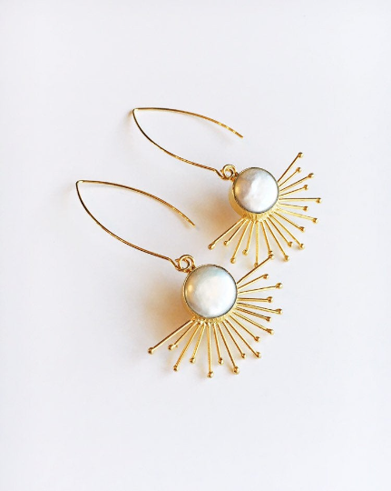 Gold sunburst and pearl statement earrings.